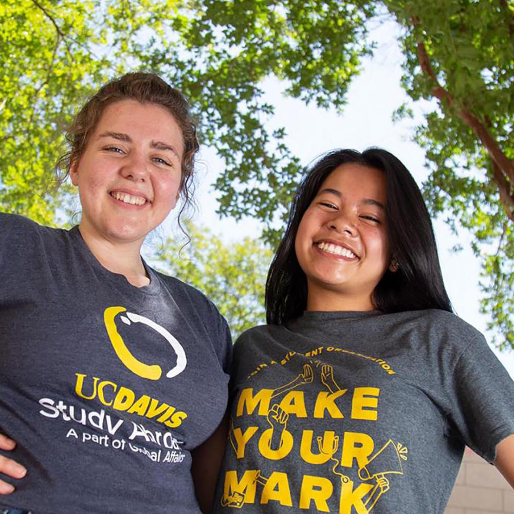 Two female students smiling outdoors